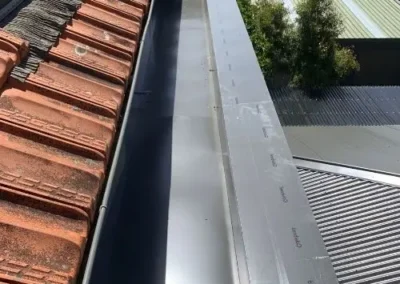 Metal ridge and flashing repairs on a residential roof
