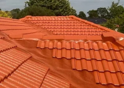 Bright terracotta tiled roof after restoration work