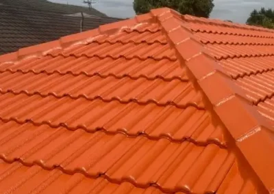 Restored orange tiled roof with renewed ridge capping