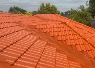 Completed terracotta tile roof restoration on a residential property