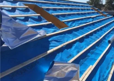 Roof frame with blue sarking and battens ready for new roofing